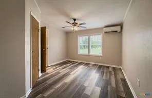 a bathroom with a granite countertop toilet and a sink