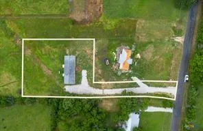 a view of a house with backyard and trees