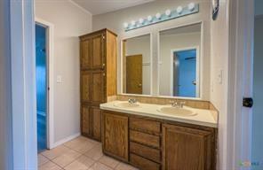 3627 North Katy Road Ross, TX 76640 - Photo 23 of 31 Full bath featuring double vanity and light tile patterned floors