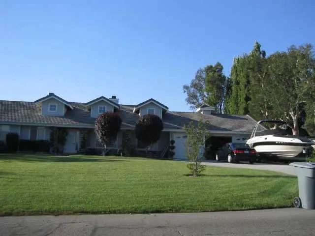 a front view of house with yard and green space