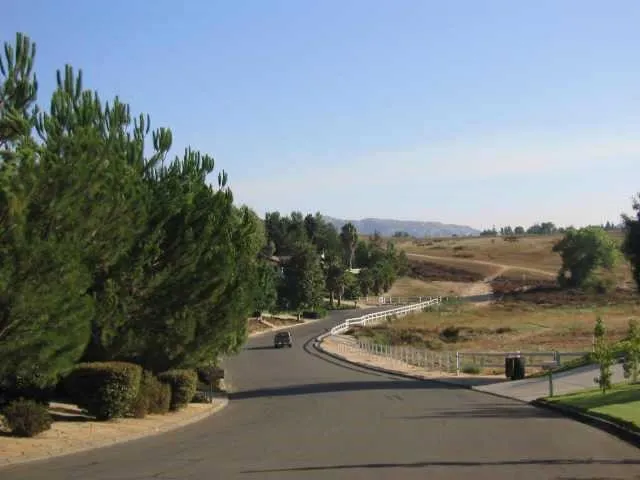 a view of a street with a building in the background