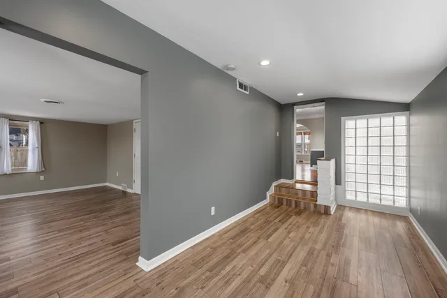 wooden floor in an empty room with a window