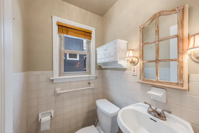 a bathroom with a sink a mirror and a toilet