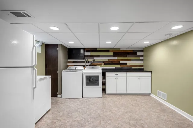 a kitchen with stainless steel appliances a refrigerator sink and stove top oven