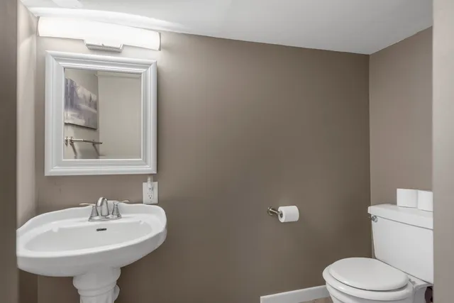 a bathroom with a sink a mirror and a toilet