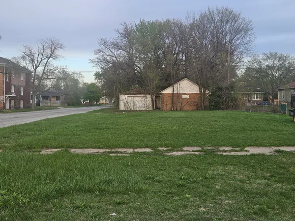 a backyard of a house with lots of green space and fountain