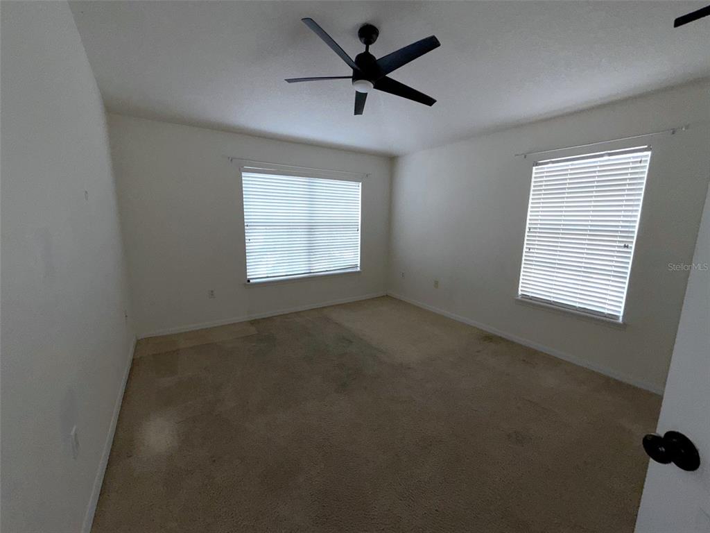 5318 Anhinga Trail New Port Richey, FL 34653 - Photo 13 of 17 an empty room with a window and a fan