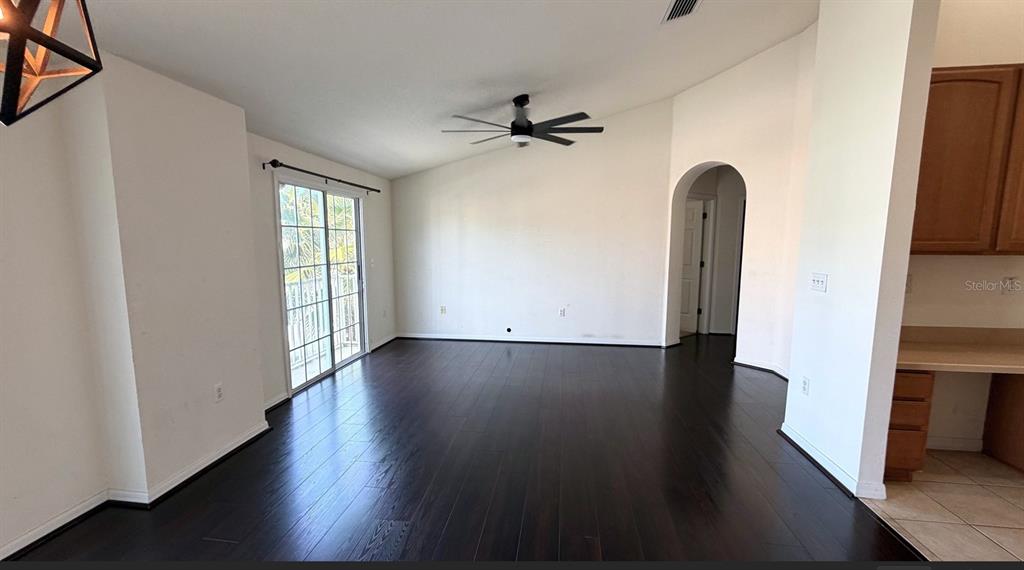 5318 Anhinga Trail New Port Richey, FL 34653 - Photo 4 of 17 wooden floor in an empty room with a window