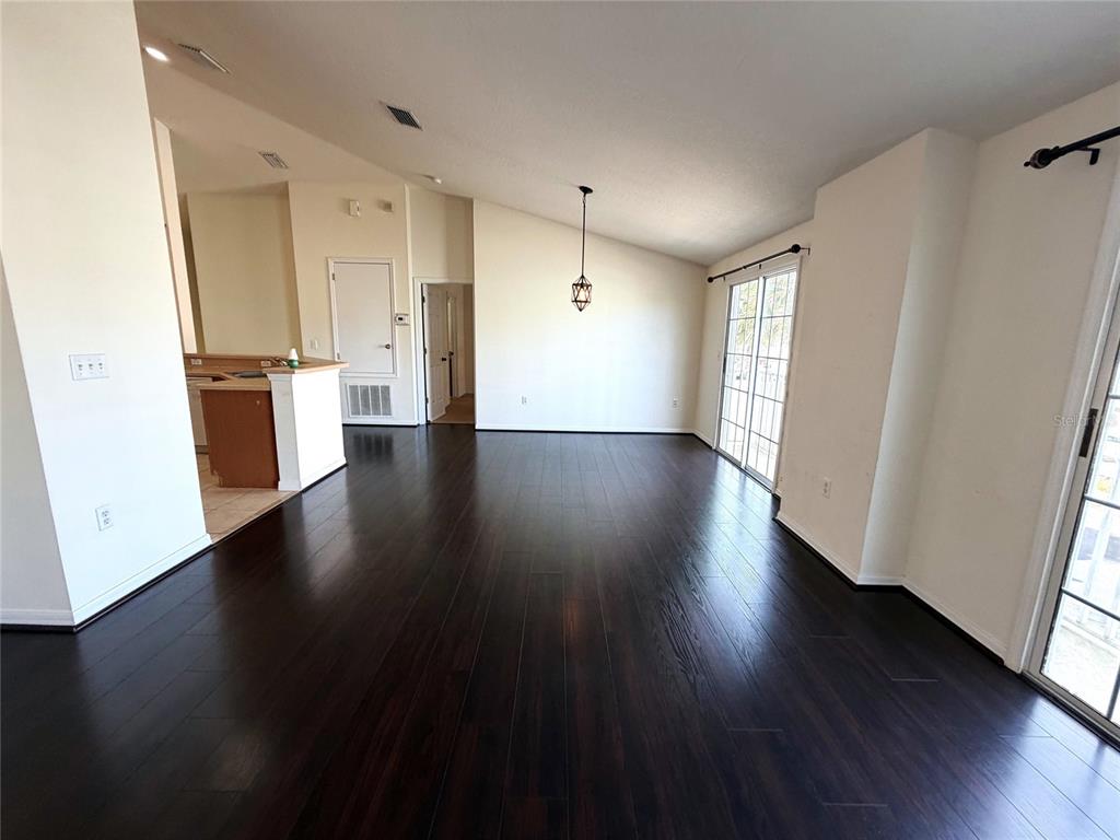 5318 Anhinga Trail New Port Richey, FL 34653 - Photo 7 of 17 an empty room with wooden floor and windows