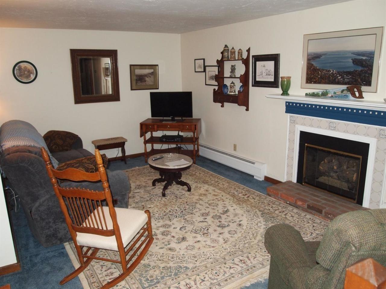 161 Capn Crosby Road Centerville, MA 02632 - Photo 15 of 23 a living room with furniture a flat screen tv and a fireplace