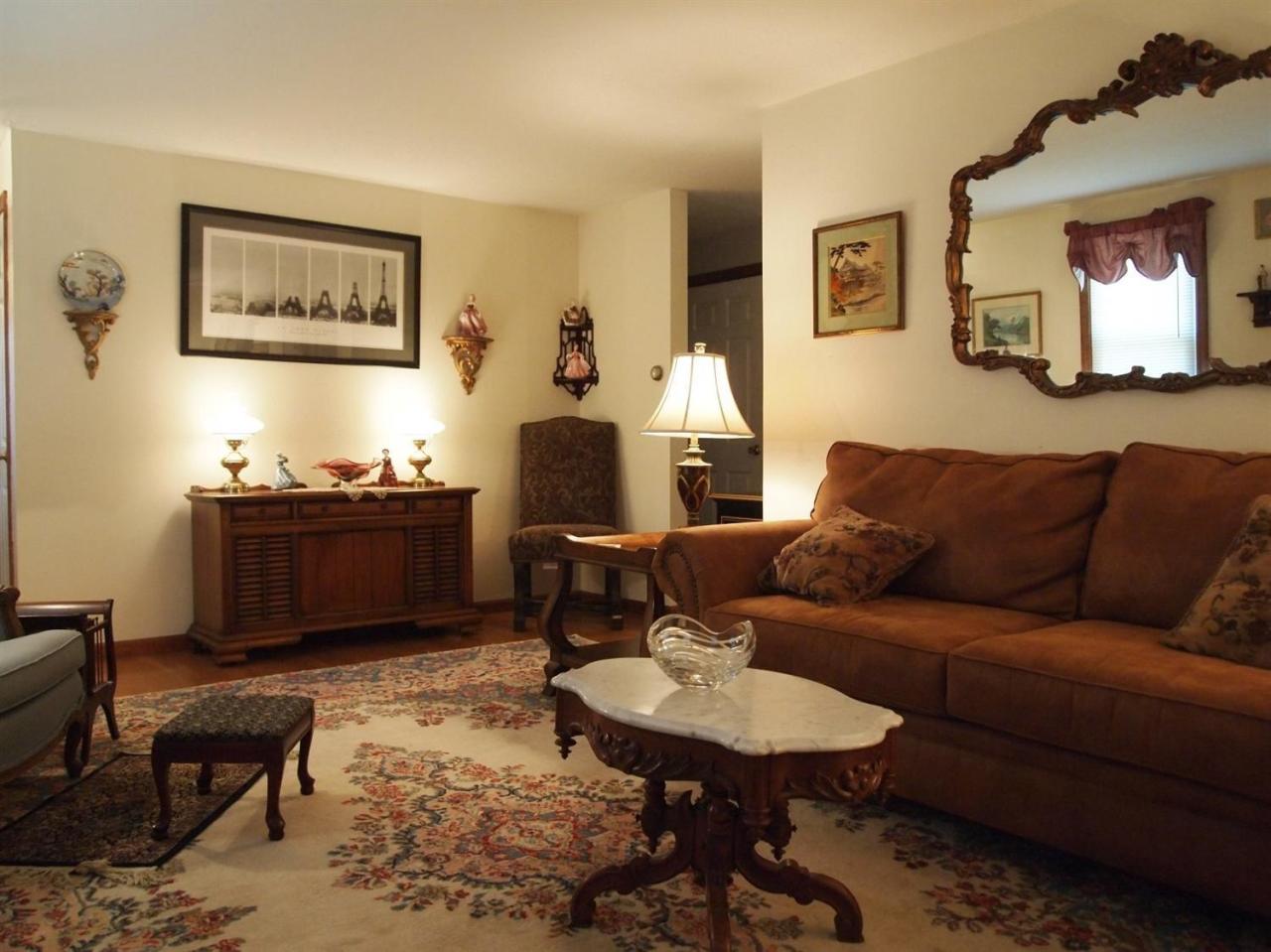 161 Capn Crosby Road Centerville, MA 02632 - Photo 2 of 23 a living room with furniture a rug and a painting on the wall