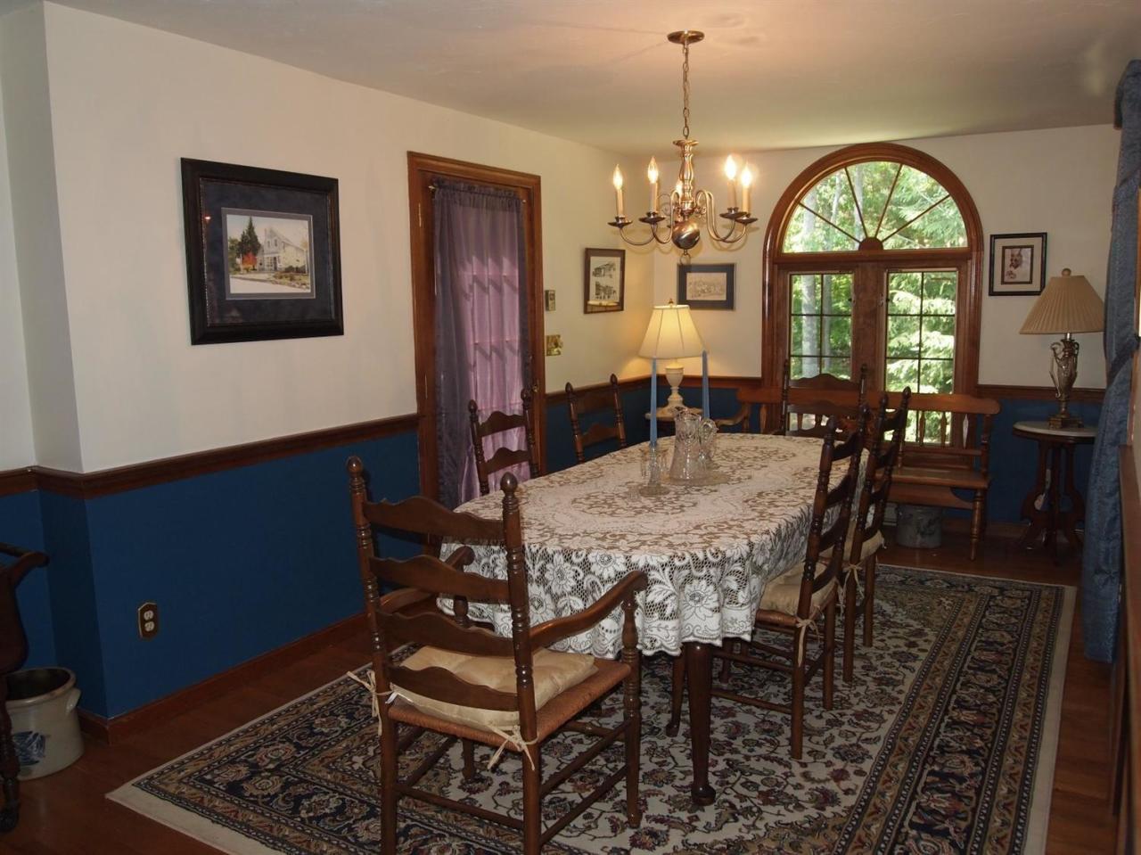 161 Capn Crosby Road Centerville, MA 02632 - Photo 6 of 23 a view of a dining room with furniture and a chandelier