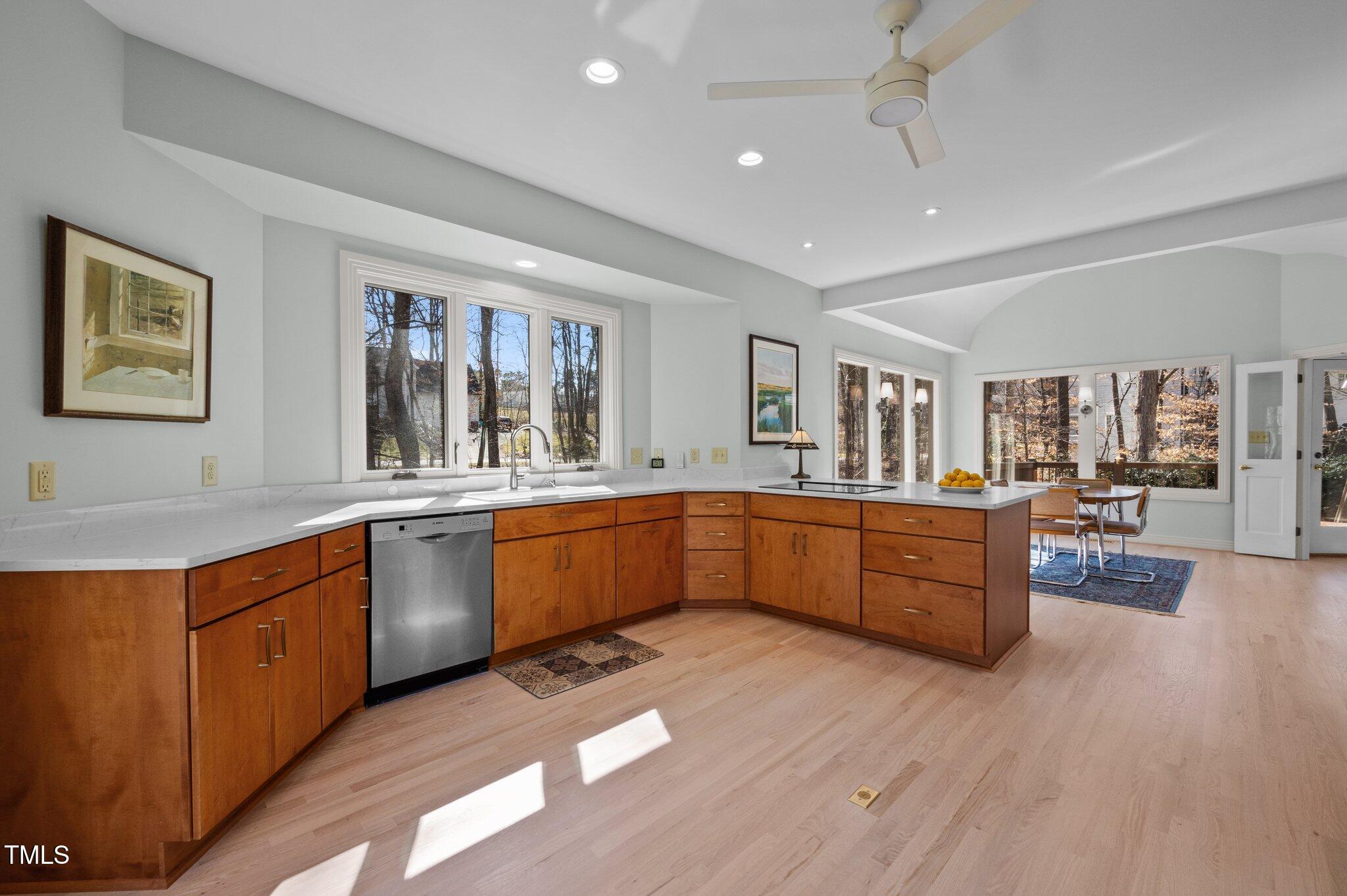 8804 Ross Court Raleigh, NC 27613 - Photo 11 of 38 a large kitchen with stainless steel appliances granite countertop a lot of counter space and wooden floors