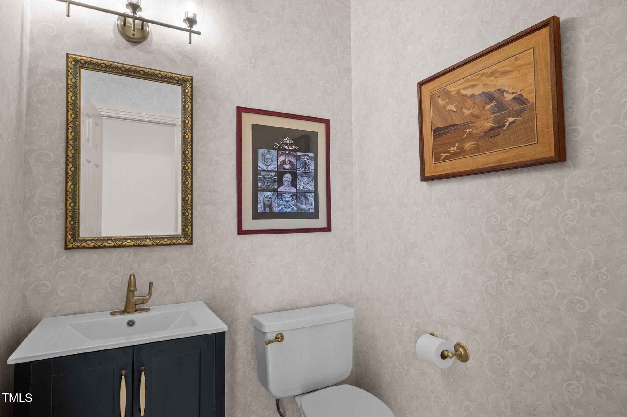 8804 Ross Court Raleigh, NC 27613 - Photo 16 of 38 a bathroom with a toilet a sink and mirror