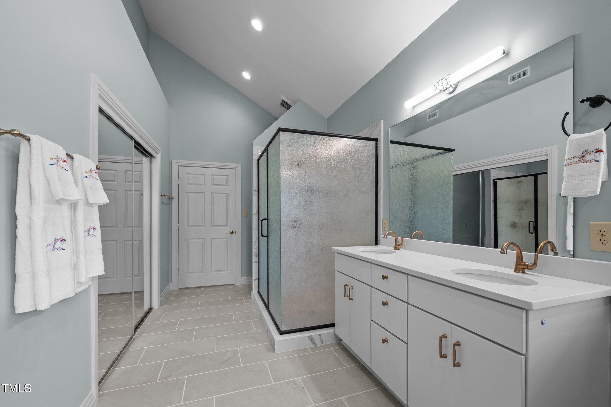 8804 Ross Court Raleigh, NC 27613 - Photo 18 of 38 a bathroom with a double vanity sink mirror and shower