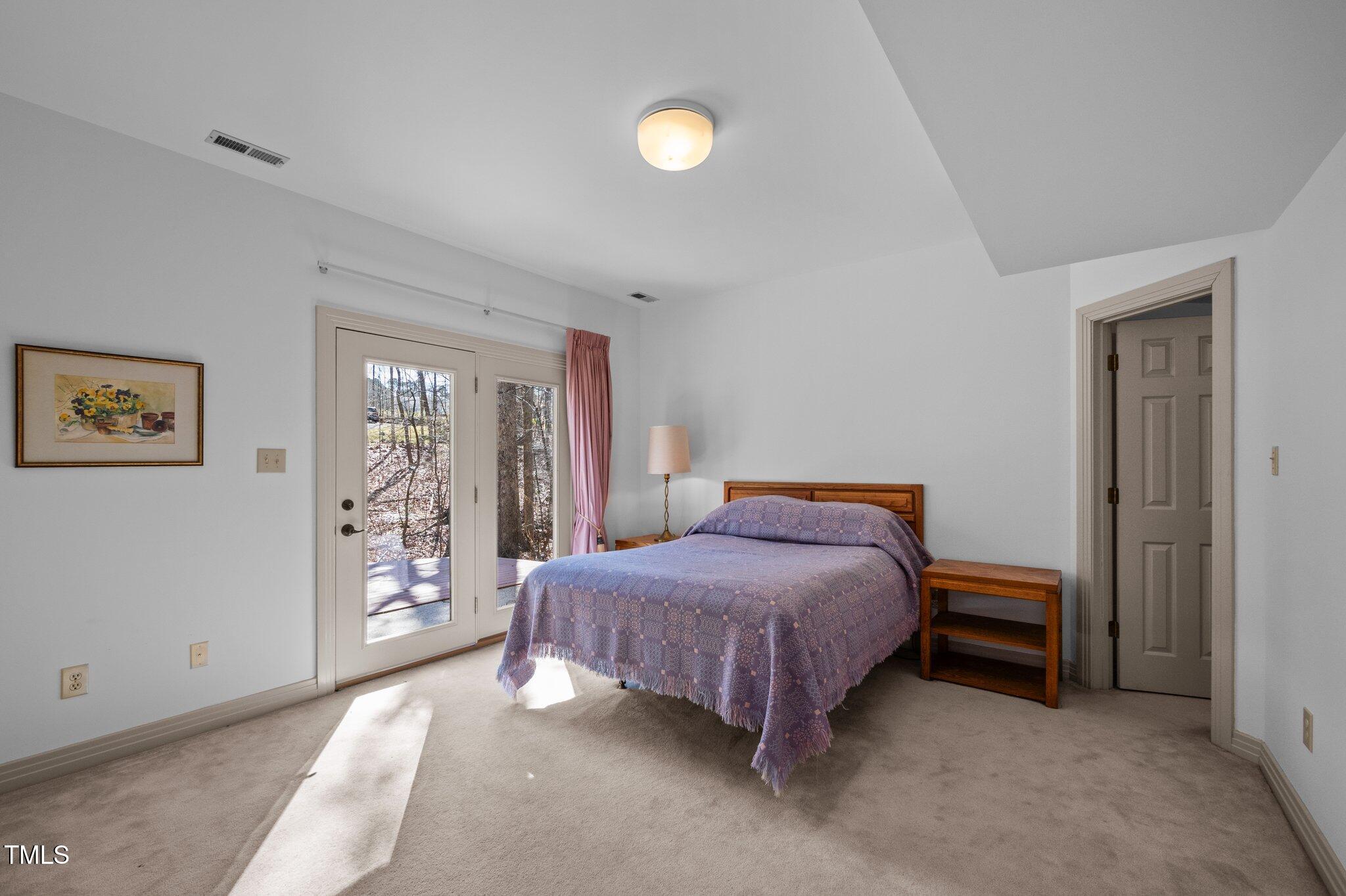 8804 Ross Court Raleigh, NC 27613 - Photo 23 of 38 a bedroom with a bed and a window