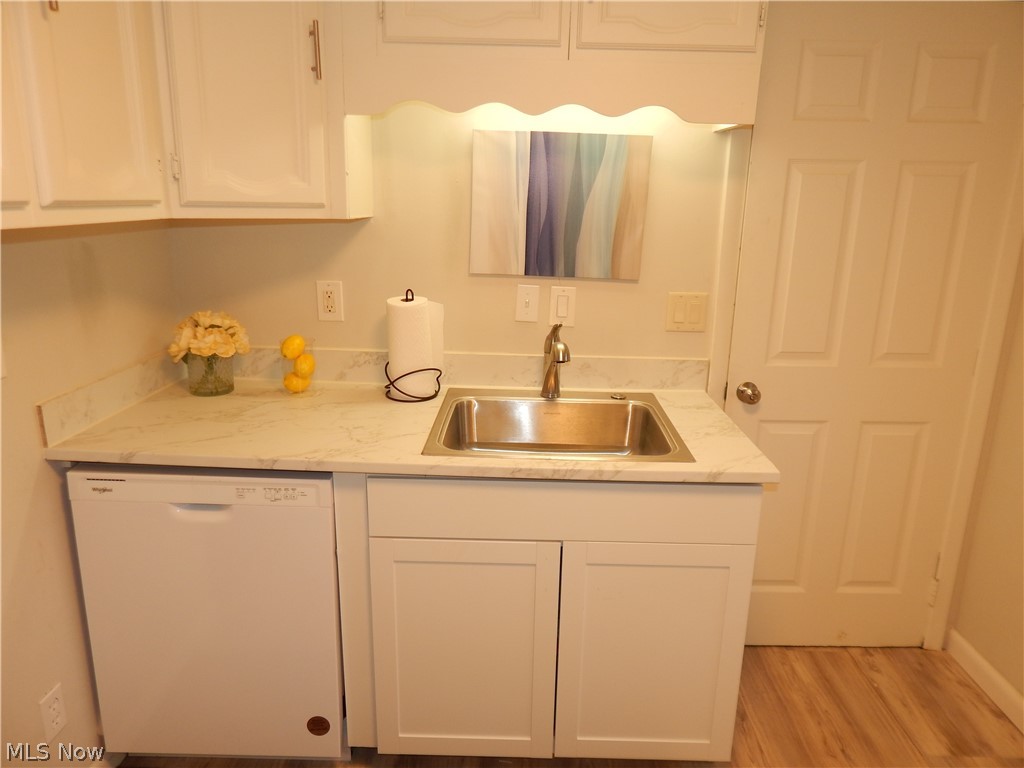 8553 Broadview Road Broadview Heights, OH 44147 - Photo 7 of 20 Kitchen with new countertops, dishwasher, white cabinetry, sink, and light wood-type flooring