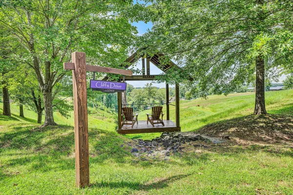 a backyard of a house with yard and outdoor seating