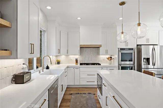 a kitchen with a sink stove and refrigerator