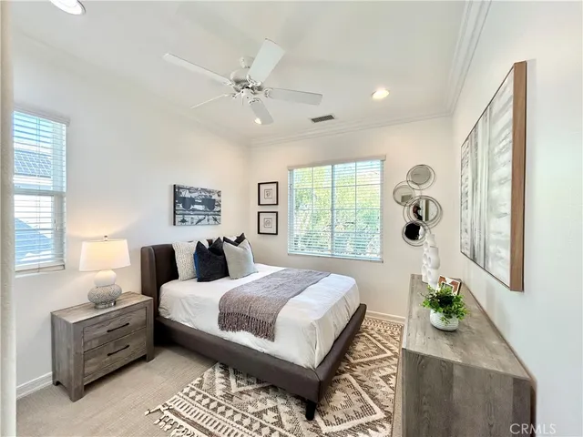 a bedroom with a large bed and a chandelier