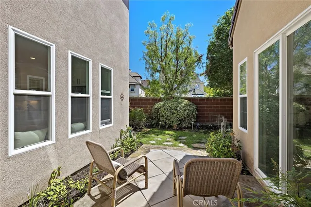 a view of chair and table in patio with potted plant
