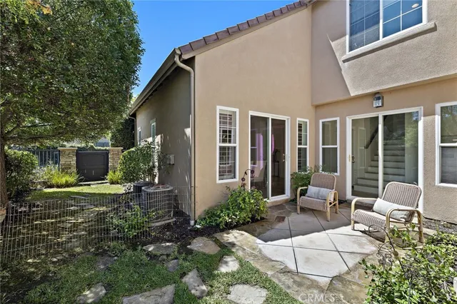 a view of a house with backyard and sitting area