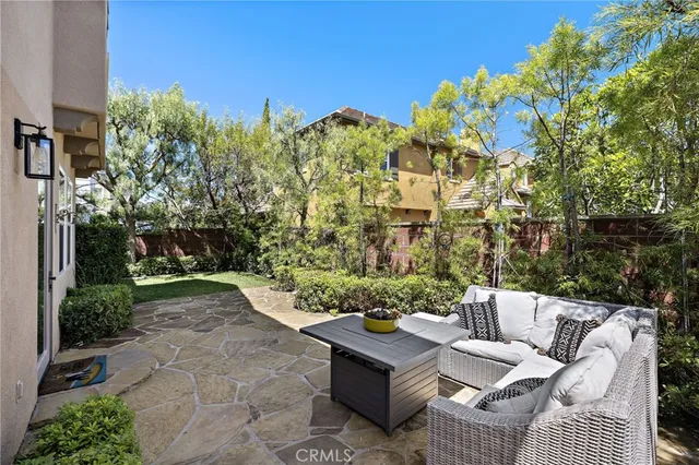 a view of a backyard with couches chair and a fire pit