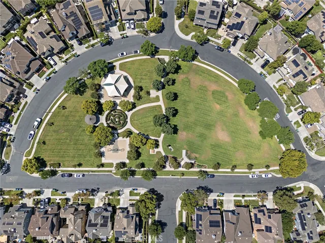 an aerial view of a residential building and outdoor space