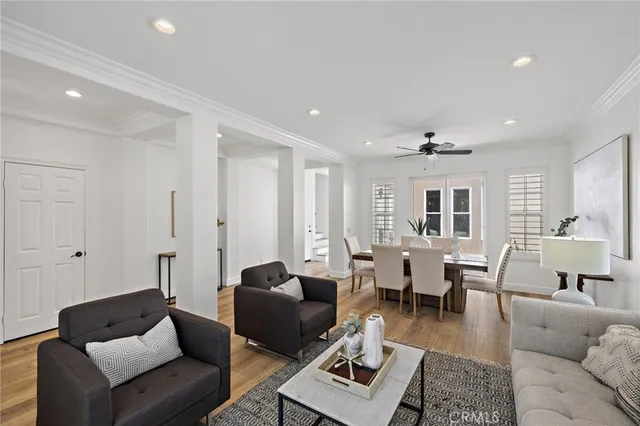 a living room with furniture wooden floor and a table