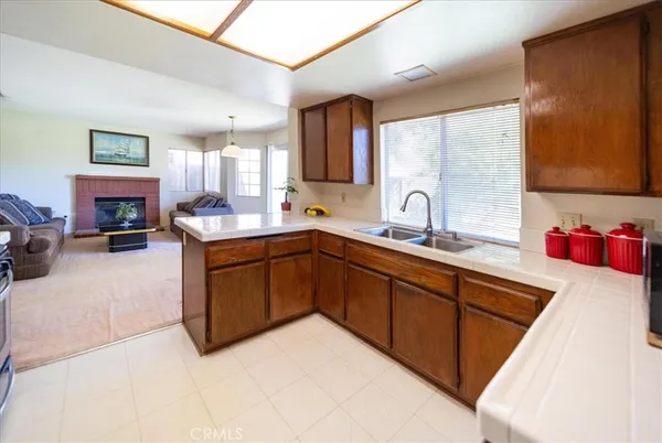 a kitchen with a sink and a wooden cabinets