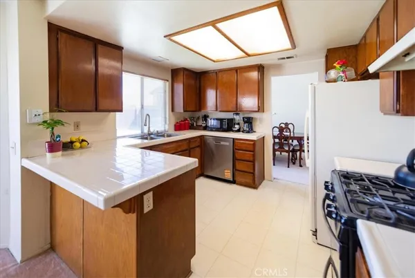 a kitchen with a stove a sink and a refrigerator