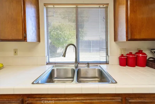 a kitchen with a sink cabinets and a window