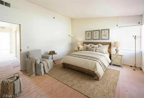 a bedroom with a bed and a couch