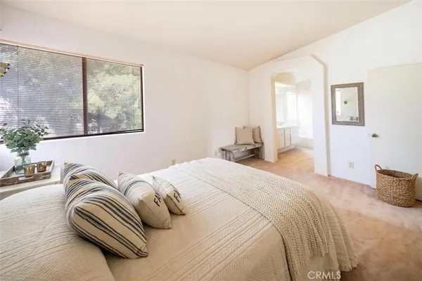 a bedroom with bed and a window