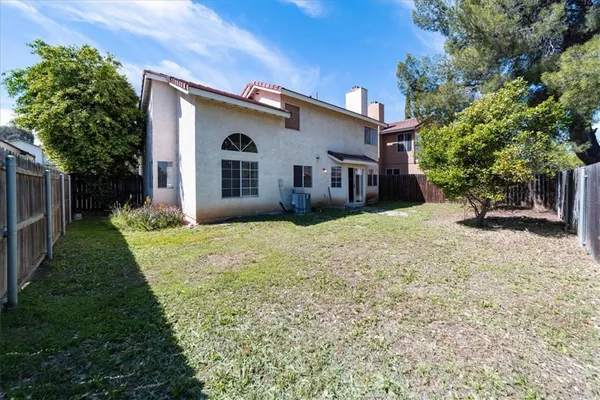 a view of a house with backyard and sitting area