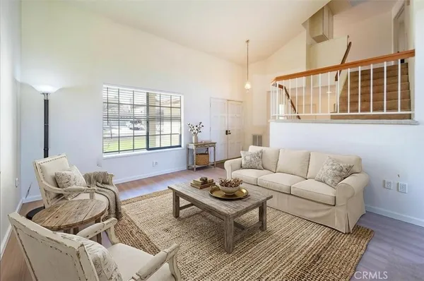 a living room with furniture a rug and a window
