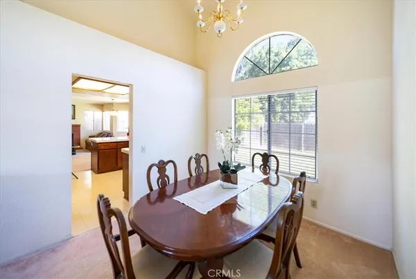 a view of a a dining room with furniture window and outside view