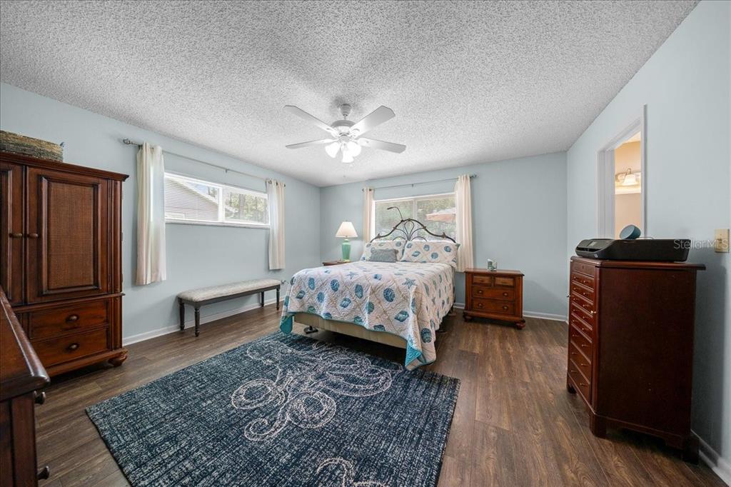 8720 Southwest 90th Street, Unit A Ocala, FL 34481 - Photo 36 of 71 a bedroom with a bed and wooden floor