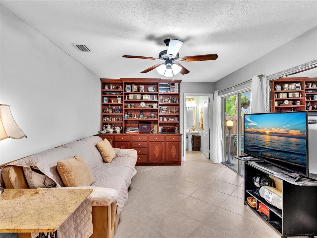 11240 Reveille Road Cooper City, FL 33026 - Photo 22 of 97 Here is the family room with bigger sofa. Bookcase is now white.