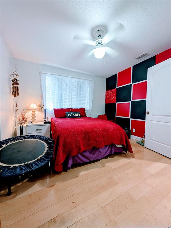 11240 Reveille Road Cooper City, FL 33026 - Photo 44 of 97 a bedroom with a bed and a chandelier