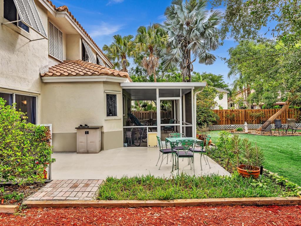 11240 Reveille Road Cooper City, FL 33026 - Photo 60 of 97 a view of a patio with couches table and chairs and potted plants