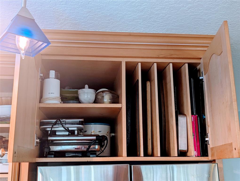 11240 Reveille Road Cooper City, FL 33026 - Photo 93 of 97 Additional custom storage over fridge. All corners are also custom. No waisted space.