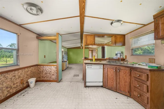 a spacious bathroom with a granite countertop sink mirror and a bathtub
