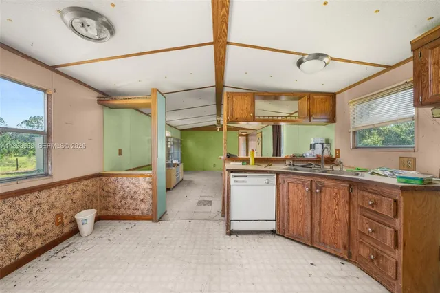 a spacious bathroom with a granite countertop sink mirror and a bathtub