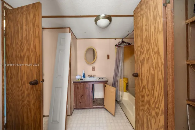 a bathroom with a mirror vanity and shower