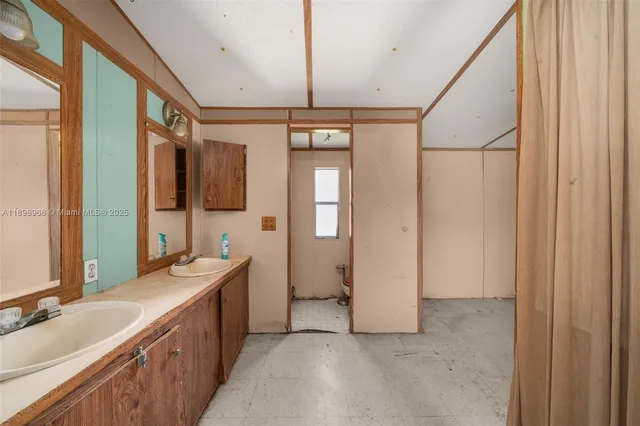 a bathroom with a double vanity sink mirror and shower