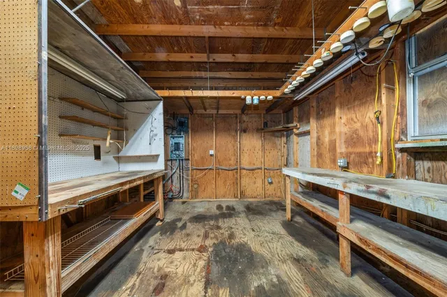 a view of a backyard with table and chairs potted plants and palm trees
