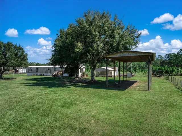 a view of a house with backyard sitting area and garden