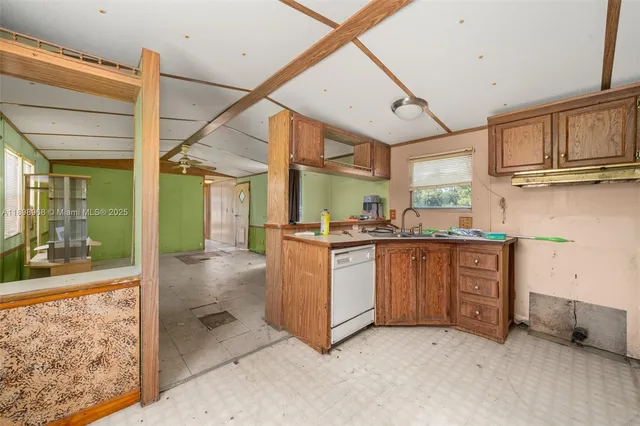 a kitchen with granite countertop a sink and cabinets