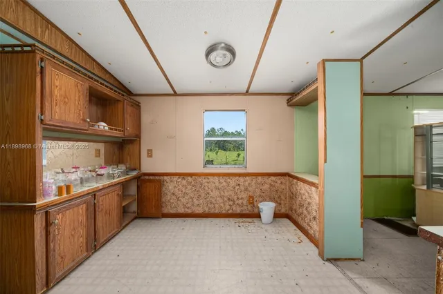 a kitchen with stainless steel appliances granite countertop a refrigerator and a stove